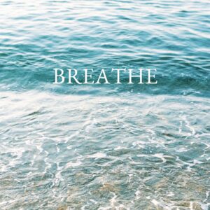Serene ocean waves with 'Breathe' text inspire calm and reflection.